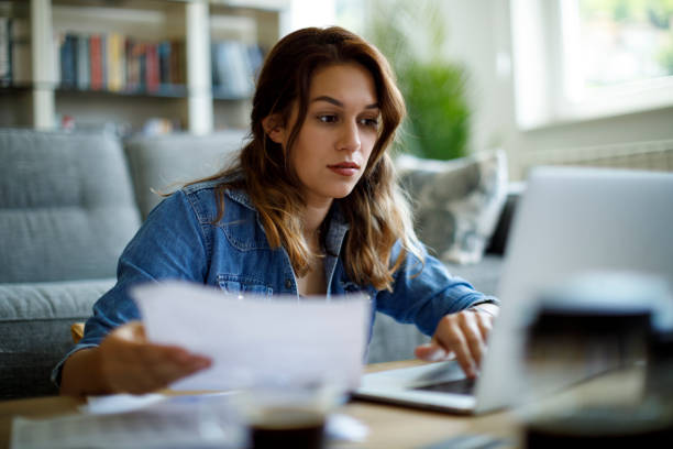 istock Woman paying her utility bills online 1423646245