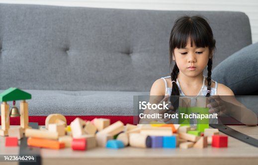 istock Cute Asian little girl playing with colorful toy blocks, Kids play with educational toys at kindergarten or daycare. The creative playing of the kid development concept, Toddler kid in the nursery. 1423646294