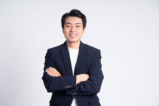 Young business man wearing a suit posing on a white background