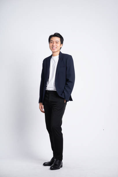 istock Young business man wearing a suit posing on a white background 1423646314