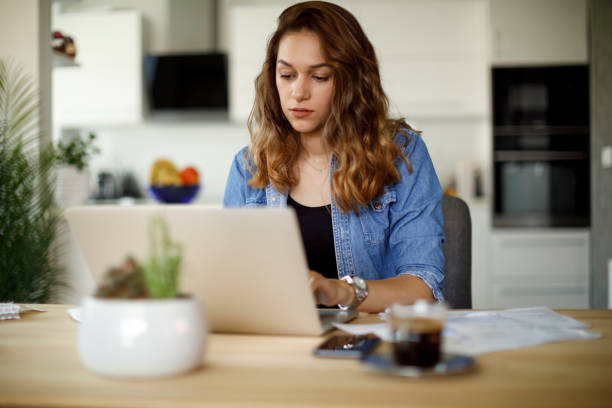 istock Woman paying her utility bills online 1423646362