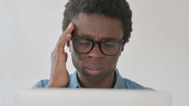 istock Close Up of Young African Man having Headache while Working on Laptop 1423646934