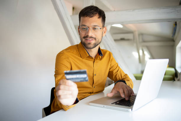 istock Man using her credit card to shop online 1423648988