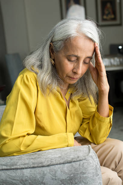 istock Old woman suffering with headache 1423655712