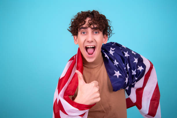 istock Young attractive guy with a flag posing in the studio. 1423655742