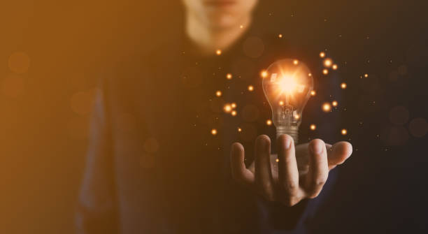 istock businessman holding a light bulb graphic Digital technology abstract. imagine an idea Creative and innovative. brain to brainstorm ideas in business. Strategies for development, growth, and success 1423656351