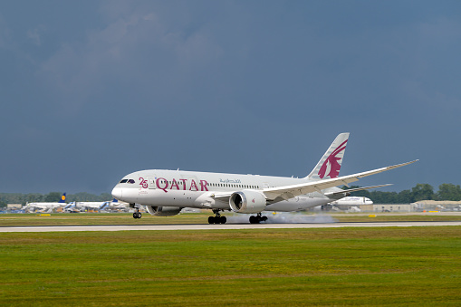Munich, Germany - August 26. 2022 : Qatar Airways Boeing 787-8 Dreamliner with the aircraft registration A7-BDA is landing on the southern runway 26L of the Munich Airport MUC EDDM