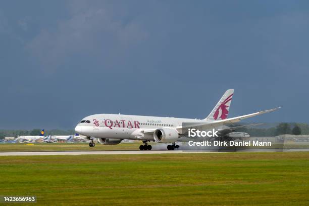 Qatar Airways Boeing 7878 Dreamliner With The Aircraft Registration A7bda Is Landing On The Southern Runway 26l Of The Munich Airport Muc Eddm Stock Photo - Download Image Now
