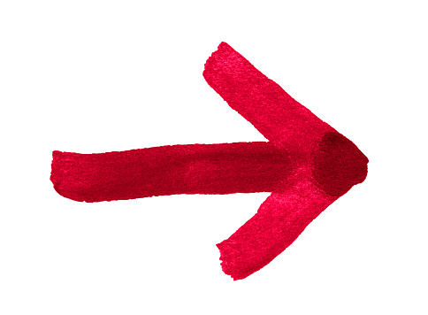 Red arrow to the right drawn with a brush on paper.