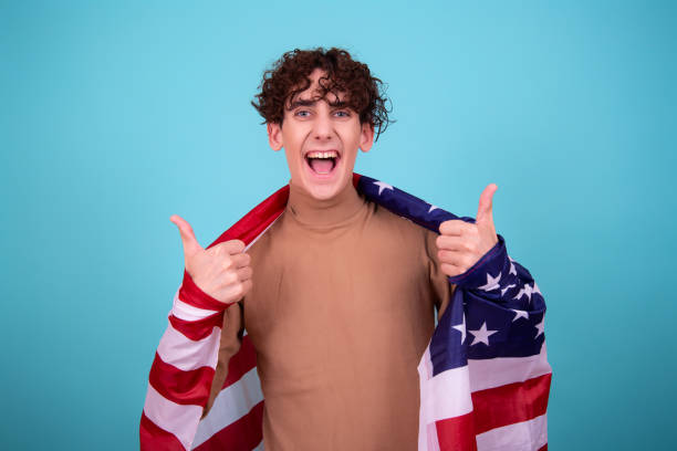 istock Young attractive guy with a flag posing in the studio. 1423658548