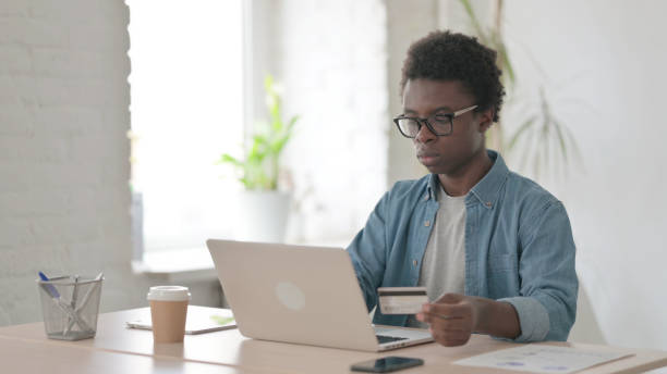 istock Successful Online Payment on Laptop by Young African Man 1423659218