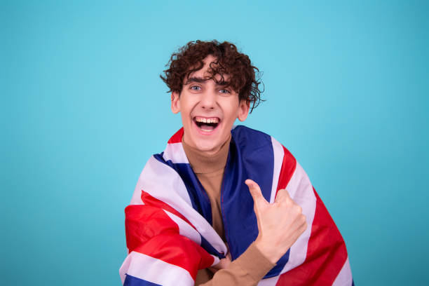 istock Young attractive guy with a flag posing in the studio. 1423661909