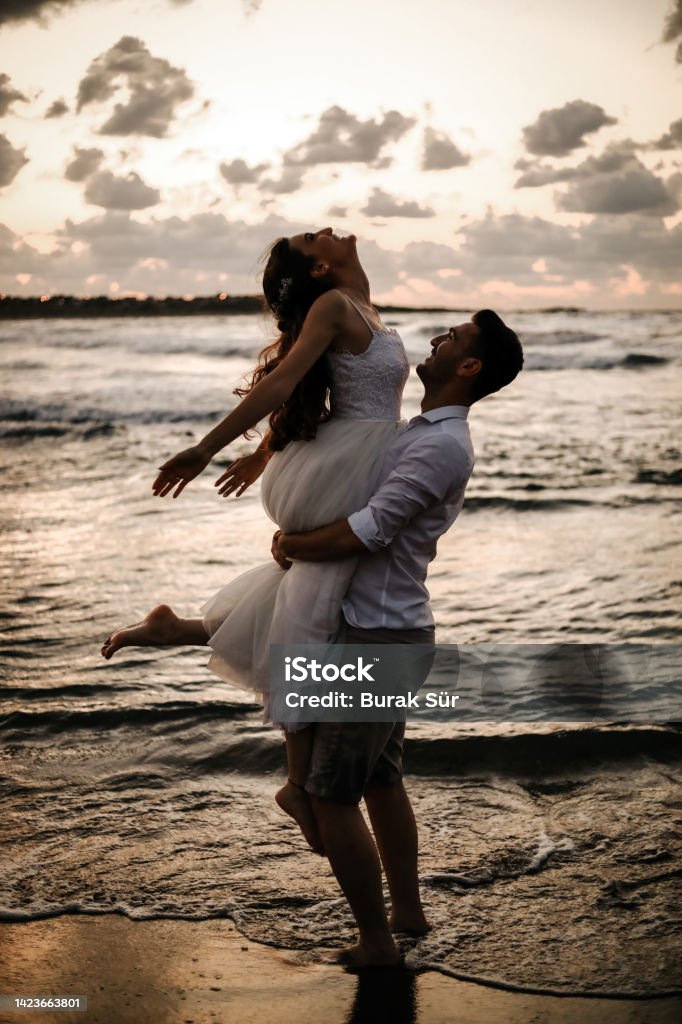 Honeymoon , Newlywed Couple On The Beach, Silhouette , Wedding Concept Adult Stock Photo