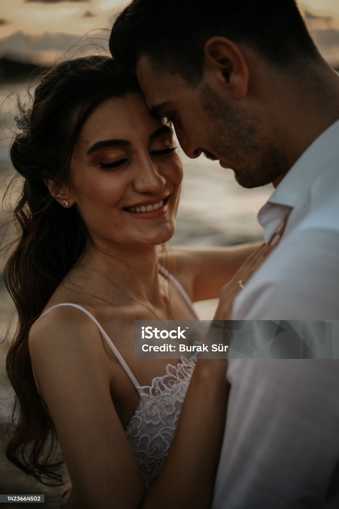Honeymoon , Newlywed Couple On The Beach, Silhouette , Wedding Concept Adult Stock Photo