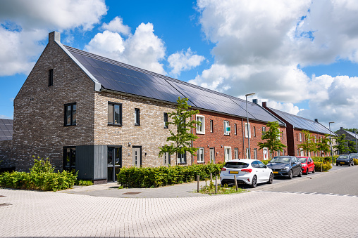 Row houses with the rooftop covered with solar panels in a new housing development
