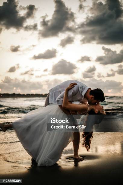 Honeymoon Newlywed Couple On The Beach Silhouette Wedding Concept Stock Photo - Download Image Now