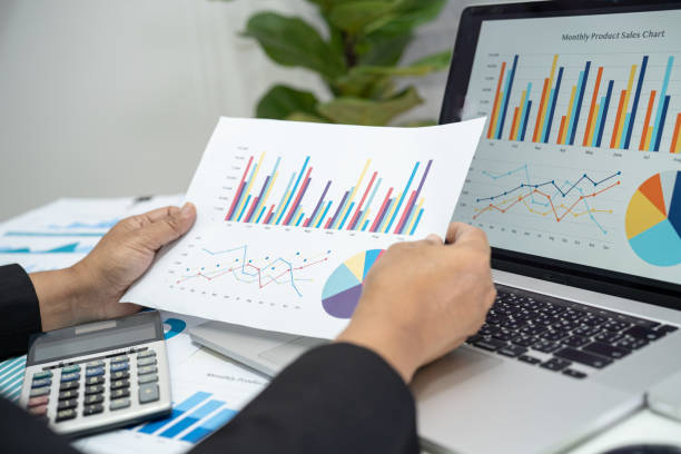 istock Asian accountant working and analyzing financial reports project accounting with chart graph and calculator in modern office, finance and business concept. 1423665346