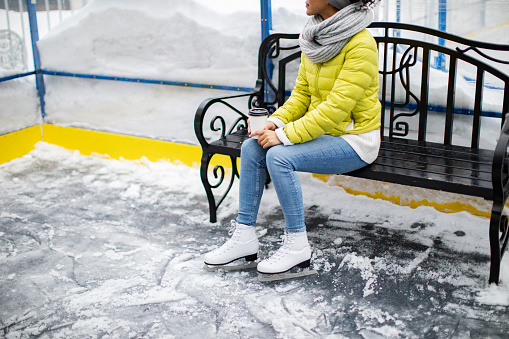 Portrait of teenage girl lying on the snow and looking at camera