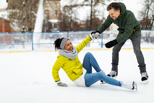 Young adult couple ice skating