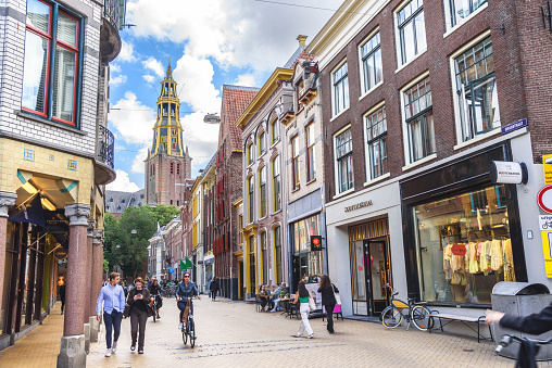 Groningen, The Netherlands - June 20, 2022: View of Brugstraat lined with historic buildings in the old city centre. The street is named after a medieval family of Ten Brugge , who lived in a stone house near the bridge.