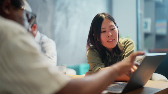 Asian businesswoman collaboration with Black ethnic businessman in modern office working space