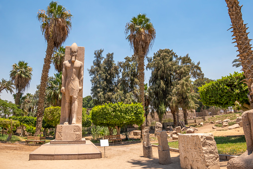 Memphis, Egypt - July 19, 2022: Memphis or Men-nefer was the ancient capital of Inebu-hedj, the first nome of Lower Egypt. Its ruins are located near the modern town of Mit Rahina, 20 km (12 mi) south of Giza in Greater Cairo, Egypt.\nDuring the time of the New Kingdom, and especially under the reign of the rulers of the Nineteenth Dynasty, Memphis flourished in power and size, rivalling Thebes both politically and architecturally. An indicator of this development can be found in a chapel of Seti I dedicated to the worship of Ptah. After more than a century of excavations on the site, archaeologists have gradually been able to confirm the layout and expansion of the ancient city.