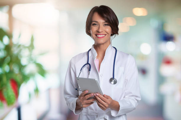 Attractive female doctor portrait while standing at the hospital's corner stock photo