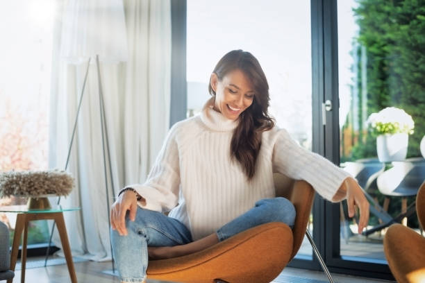 istock Happy woman relaxing at home 1423677346
