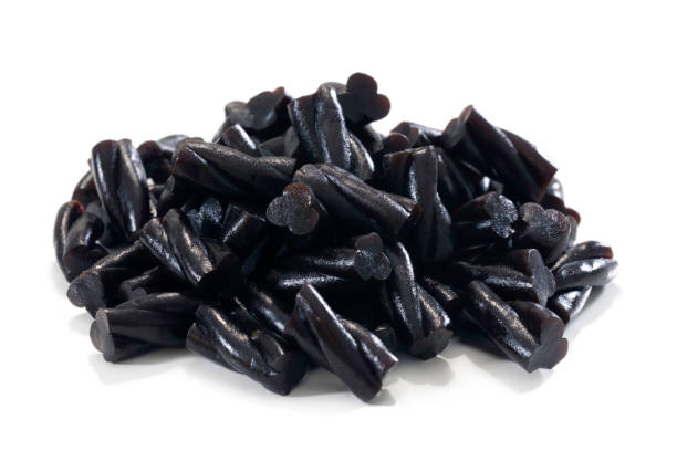 few coiled black licorice candies isolated on white background