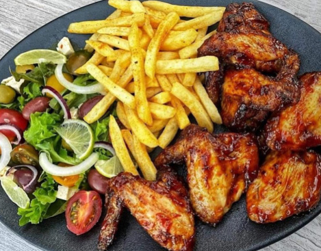 Perfect dinner meal fried chicken wings with fries and fresh salad nice combination