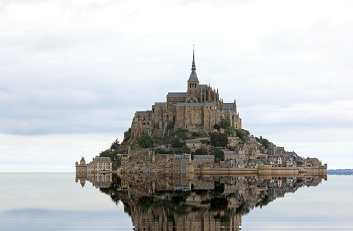 reflection of the sea and the famous Abbey of Mont Saint Michel in France