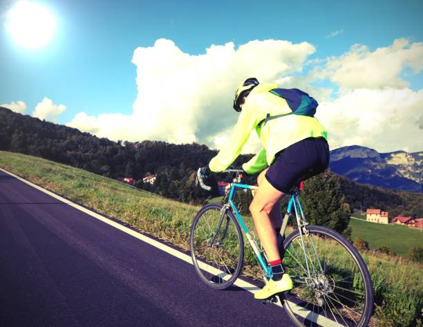 istock young cyclist with racing bicycle and phosphorescent waterproof jacket on the road 1423679972