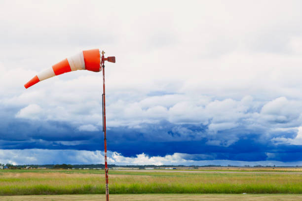 Flying windsock or wind vane and stormy sky background