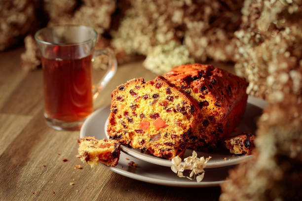 istock Fruit cake and tea on a wooden table with dried flowers. 1423680276