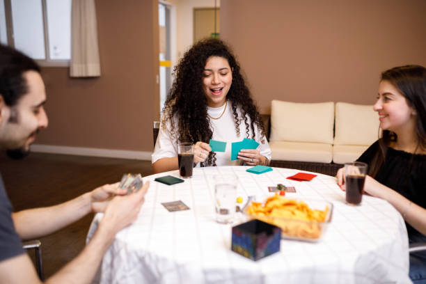 istock Friends enjoying playing cards together 1423680431