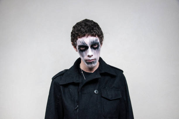 Young man with facial paint on a white background