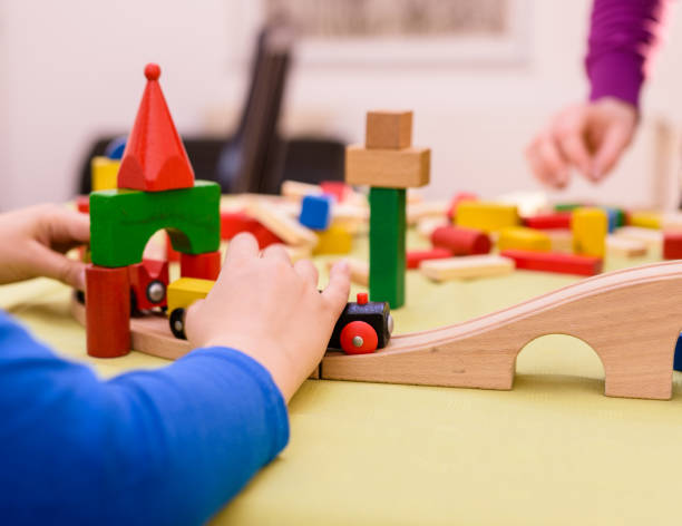 istock Cute young boy is playing with toy blocks 1423686987