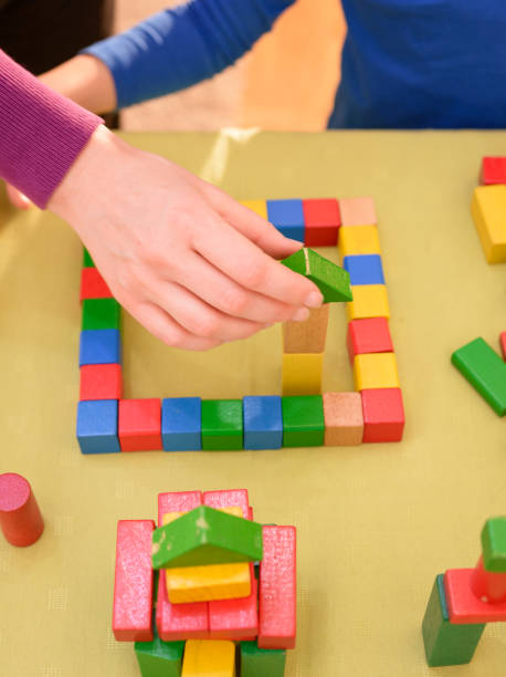 istock Cute young boy is playing with toy blocks 1423687021