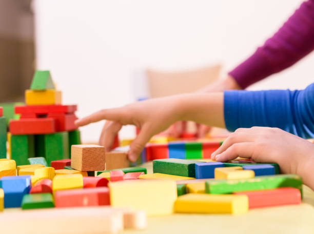 istock Cute young boy is playing with toy blocks 1423687039