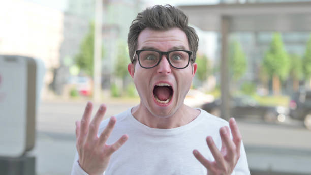 istock Angry Young Man Screaming in Frustration Outdoor 1423689374