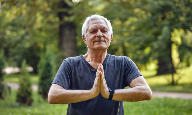 istock Older active man do meditation practice outdoors 1423691201