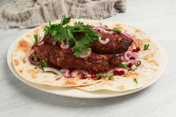 istock Lula kebab, on lavash, with red onion, pomegranate, and sumac, top view, close-up, horizontal, no people, 1423701387