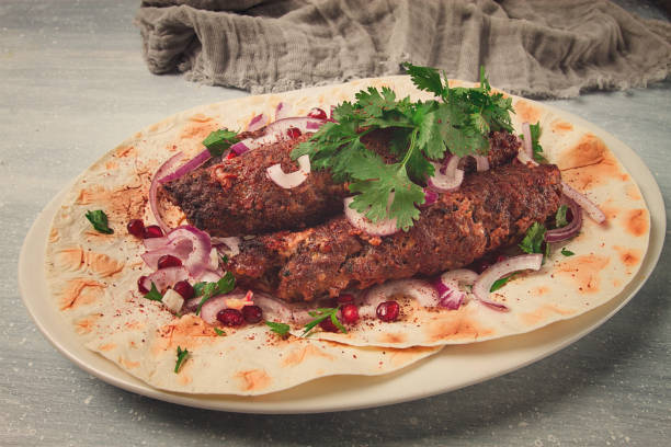 istock Lula kebab, on lavash, with red onion, pomegranate, and sumac, top view, close-up, horizontal, no people, 1423703555