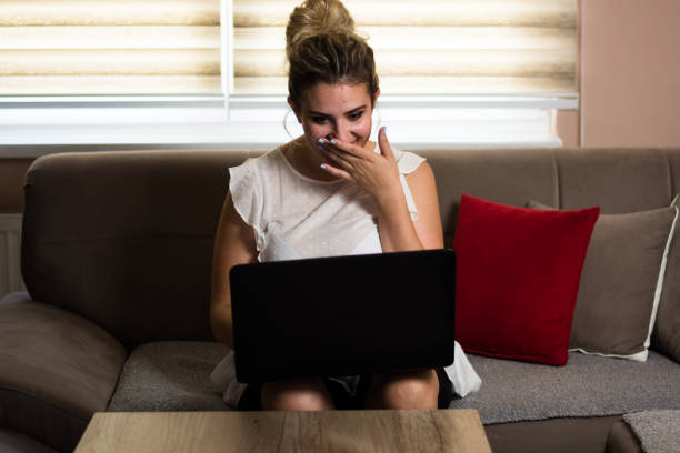 istock Happy young  woman working on computer at home 1423703629