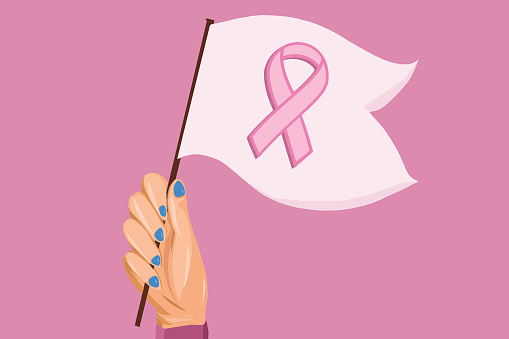Person holding up a small flag of Breast Cancer Awareness
