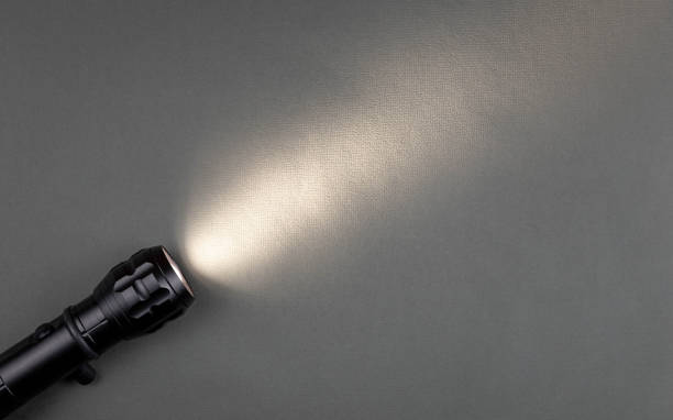 istock A bright beam of light from a flashlight shines on a gray background 1423704293