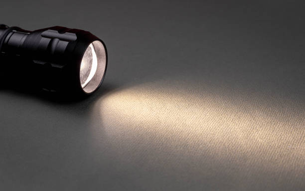 istock A bright beam of light from a flashlight shines on a gray background 1423704306