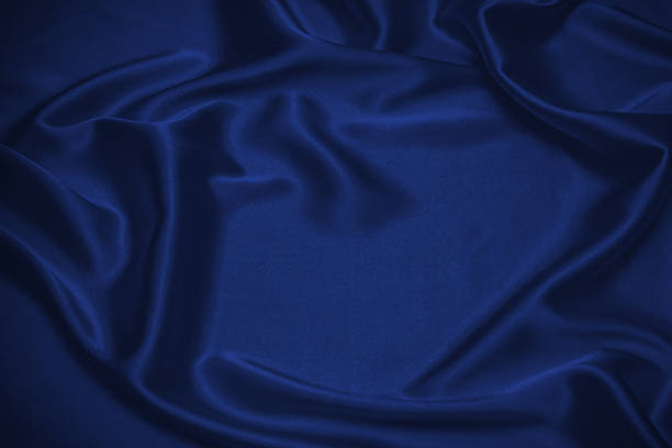 istock Rich and luxury red silk fabric texture background. 1423704530
