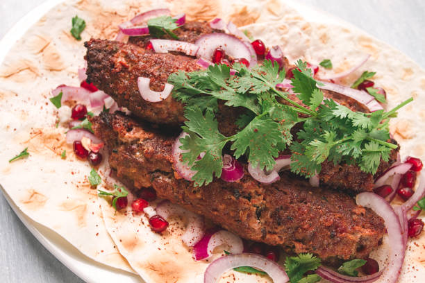 istock Lula kebab, on lavash, with red onion, pomegranate, and sumac, top view, close-up, horizontal, no people, 1423706176