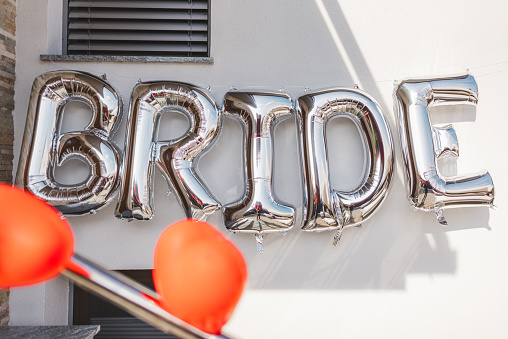 BRIDE - word made from silver gold foil balloons. party or holiday décor concept for bride at home